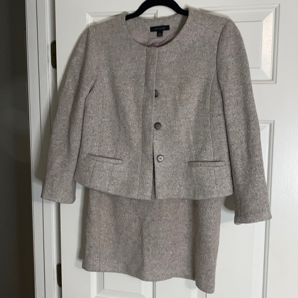 Two piece suit. Hidden buttons. Jacket is size 8 and skirt is size 6
